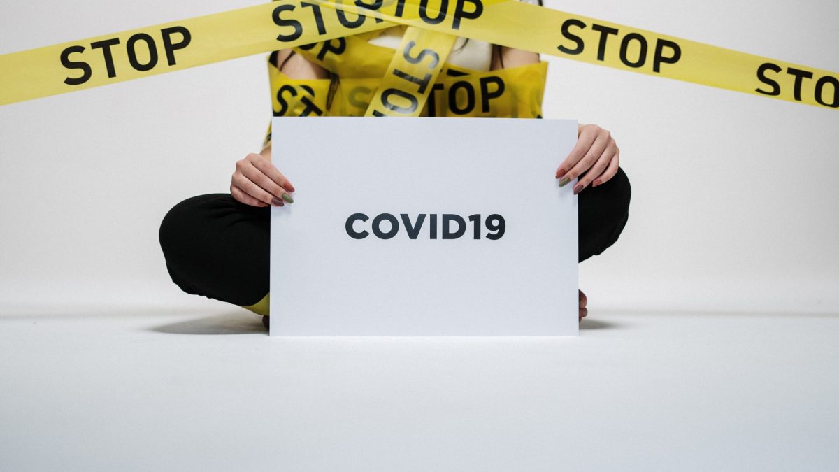 person-holding-covid-sign-3951600